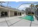 Screened pool and patio with solar panels at 5574 Sweetwater Oak, Sarasota, FL 34232