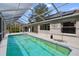 Inviting screened pool with backyard view at 5574 Sweetwater Oak, Sarasota, FL 34232