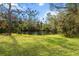 Serene waterfront view from the backyard, featuring a peaceful pond at 5574 Sweetwater Oak, Sarasota, FL 34232