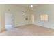 Living room features vaulted ceiling,carpet, and access to other rooms at 5612 Ashton Lake Dr # 5612, Sarasota, FL 34231