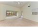 Spacious living room with vaulted ceiling, carpet, and patio access at 5612 Ashton Lake Dr # 5612, Sarasota, FL 34231