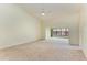 Spacious living room with vaulted ceiling, carpet, and large windows at 5612 Ashton Lake Dr # 5612, Sarasota, FL 34231