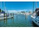 Boats docked at a marina with clear water and a city skyline in the distance at 5612 Ashton Lake Dr # 5612, Sarasota, FL 34231