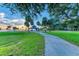 Scenic park with a gazebo, palm trees, and a walking path at sunset at 5612 Ashton Lake Dr # 5612, Sarasota, FL 34231