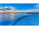 Serene waterfront scene with a pier and a picturesque sunset at 5612 Ashton Lake Dr # 5612, Sarasota, FL 34231