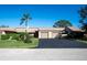 Tan colored exterior of a two-story home with a two car garage and manicured lawn at 5640 Westwind Ln, Sarasota, FL 34231