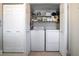 Bright laundry room with washer, dryer, and shelving at 5640 Westwind Ln, Sarasota, FL 34231