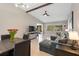 Open living room and dining area with gray sectional sofa and hardwood floors at 5640 Westwind Ln, Sarasota, FL 34231