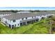 Aerial view of townhome rear elevation, showcasing private patios and yard at 5703 Tripoli Dr, Palmetto, FL 34221