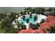 Aerial view of community pool and clubhouse with surrounding palm trees at 5703 Tripoli Dr, Palmetto, FL 34221