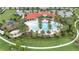 Aerial view of community pool, surrounded by lush landscaping and a playground at 5703 Tripoli Dr, Palmetto, FL 34221