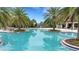 Inviting community pool with lounge chairs and families enjoying the sun at 5703 Tripoli Dr, Palmetto, FL 34221