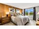 Main bedroom with wood accent wall, large window, and tranquil water views at 5703 Tripoli Dr, Palmetto, FL 34221