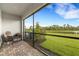 Screened porch overlooks a pond and lush landscape at 5703 Tripoli Dr, Palmetto, FL 34221