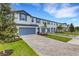 Two-story townhouses with blue garage doors and landscaping at 5703 Tripoli Dr, Palmetto, FL 34221