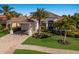 One-story house with a tile roof, landscaping, and a paved driveway at 579 Fore Dr, Bradenton, FL 34208