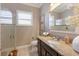 Bathroom with granite countertop, dark brown vanity, and glass shower at 579 Fore Dr, Bradenton, FL 34208