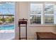 Bedroom with pool view, plantation shutters and built-in valet at 579 Fore Dr, Bradenton, FL 34208