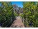 Wooden boardwalk path through lush greenery, leading to tranquil waterfront at 579 Fore Dr, Bradenton, FL 34208