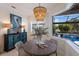 Bright breakfast nook with pool view, wooden table, and wicker chairs at 579 Fore Dr, Bradenton, FL 34208