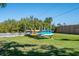 Colorful kayaks on a rack in a grassy area at 579 Fore Dr, Bradenton, FL 34208