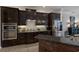 Modern kitchen with dark cabinetry, granite countertops, and stainless steel appliances at 579 Fore Dr, Bradenton, FL 34208