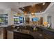 Kitchen island with granite countertop, sink, and a view of the living room at 579 Fore Dr, Bradenton, FL 34208