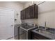 Laundry room with washer, dryer, cabinets, and granite countertop at 579 Fore Dr, Bradenton, FL 34208