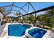 Screened pool and spa with fountain and lush landscaping at 579 Fore Dr, Bradenton, FL 34208