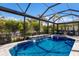 Relaxing pool and spa with waterfall features in screened enclosure at 579 Fore Dr, Bradenton, FL 34208