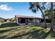 Screened patio and grassy backyard with palm trees at 6115 Twig Cir # 6D, Bradenton, FL 34209