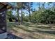 Private backyard with grassy area and trees at 6115 Twig Cir # 6D, Bradenton, FL 34209