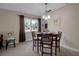 Dining area with table and chairs near window overlooking backyard at 6115 Twig Cir # 6D, Bradenton, FL 34209