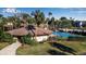 Community pool and clubhouse with lush landscaping at 6115 Twig Cir # 6D, Bradenton, FL 34209