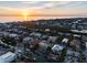 Waterfront homes with canal access, lush vegetation, and a beautiful sunset. The home has a tile roof and yellow exterior at 614 Norton St, Longboat Key, FL 34228