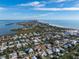 Stunning aerial view of a waterfront community with canal access and beach nearby under a bright blue partially cloudy sky at 614 Norton St, Longboat Key, FL 34228