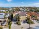 Aerial view of a yellow two-story home, showcasing the landscaped yard and surrounding neighborhood at 614 Norton St, Longboat Key, FL 34228