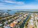 Aerial shot of a waterfront property with canal access, lush landscaping, and a sunny backyard pool area at 614 Norton St, Longboat Key, FL 34228