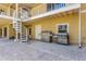 Outdoor patio area with grill and spiral staircase at 614 Norton St, Longboat Key, FL 34228