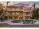 Back of house showing multi-level balconies and a pool and outdoor seating at 614 Norton St, Longboat Key, FL 34228