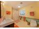 Whimsical bathroom with ocean-themed mural, modern vanity, and decorative tile floor at 614 Norton St, Longboat Key, FL 34228