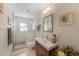 Bright bathroom featuring a glass-enclosed shower, modern vanity, and beach-themed decor at 614 Norton St, Longboat Key, FL 34228