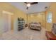 Bright bedroom featuring neutral walls, tile floors, ceiling fan, and a closet for organized storage and restful sleep at 614 Norton St, Longboat Key, FL 34228