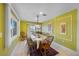 Dining room features a decorative light fixture, decorative walls, and a sliding glass door to the patio at 614 Norton St, Longboat Key, FL 34228