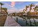 Waterfront property with a private dock and boats under a beautiful pink and blue sky at 614 Norton St, Longboat Key, FL 34228