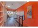 Bright hallway with built-in bookshelves, modern railing, and slider to an outdoor patio perfect for reading at 614 Norton St, Longboat Key, FL 34228