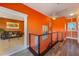 Bright hallway showcasing unique wall art, modern railing, and open view to a comfortable living room for easy access at 614 Norton St, Longboat Key, FL 34228