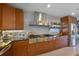 Modern kitchen featuring stainless steel appliances, custom cabinetry, and ample counter space at 614 Norton St, Longboat Key, FL 34228