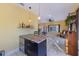 Kitchen area featuring a stylish island with seating and modern pendant lighting at 614 Norton St, Longboat Key, FL 34228