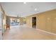 Bright, neutral living room with tile floors, ceiling fan, and sliding doors to the outdoor area at 614 Norton St, Longboat Key, FL 34228